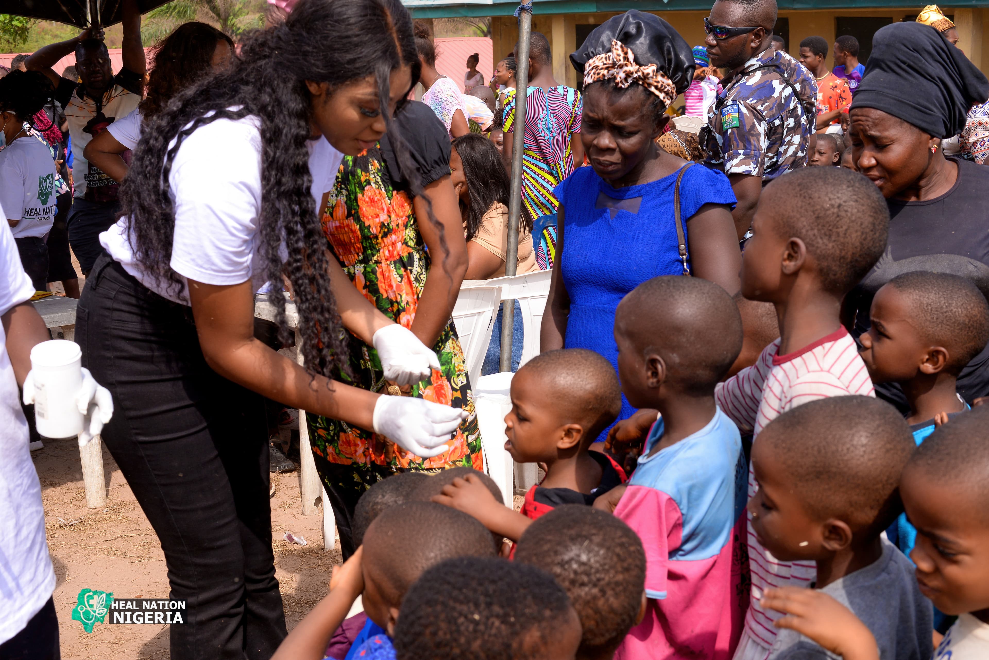 Heal Nation outreach — founder attending to community members including children