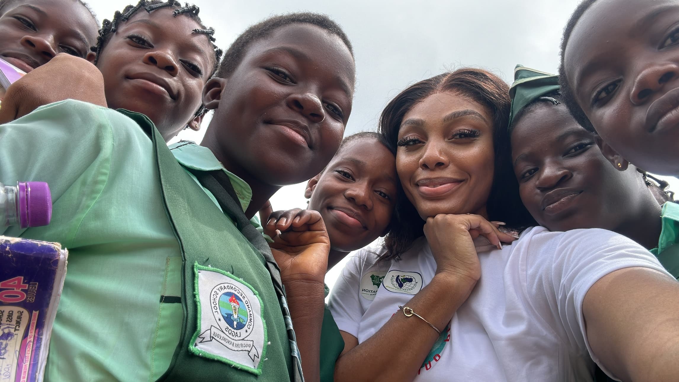 Heal Nation founder surrounded by schoolchildren in Lagos, Nigeria